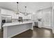 Modern kitchen boasting white cabinets, stainless steel appliances, a large center island, and hardwood floors at 4362 White Spruce Aly, Doraville, GA 30360