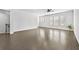 Bright living room boasts hardwood floors, neutral walls, ceiling fan, and ample natural light from large windows at 4362 White Spruce Aly, Doraville, GA 30360