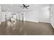 Spacious living room flowing into the kitchen, featuring modern hardwood floors, recessed lighting, and neutral walls at 4362 White Spruce Aly, Doraville, GA 30360
