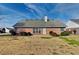 Back view of brick home with a large backyard and patio at 930 Rafington Dr, Lawrenceville, GA 30046