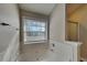 Bright bathroom with a garden tub and tiled surround, next to the glass enclosed shower stall at 930 Rafington Dr, Lawrenceville, GA 30046