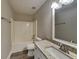 Bathroom with granite counters, sink, shower tub, and a towel rack at 930 Rafington Dr, Lawrenceville, GA 30046