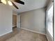 Neutral bedroom featuring a ceiling fan, window and neutral carpeting at 930 Rafington Dr, Lawrenceville, GA 30046