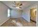 Bedroom with ceiling fan, window, and a view of a bathroom with granite counters at 930 Rafington Dr, Lawrenceville, GA 30046