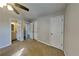 Carpeted bedroom with ceiling fan, and two doors, one leading to the bathroom at 930 Rafington Dr, Lawrenceville, GA 30046