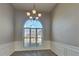Elegant dining room with large window and classic chandelier at 930 Rafington Dr, Lawrenceville, GA 30046