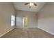 Spacious primary bedroom with ceiling fan and a door to the ensuite at 930 Rafington Dr, Lawrenceville, GA 30046