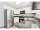 Well-lit kitchen featuring stainless steel appliances, granite countertops, and white cabinetry at 100 Nottingham Dr, Douglasville, GA 30134