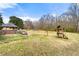 Expansive backyard featuring a covered gazebo, playset, swing set, and ample room for outdoor activities at 1710 Meadowchase Ct, Snellville, GA 30078