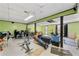 Open basement area with green walls, a drop ceiling, and gym equipment at 1710 Meadowchase Ct, Snellville, GA 30078