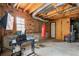 Unfinished basement with exposed rafters, a punching bag and a desk area at 1710 Meadowchase Ct, Snellville, GA 30078