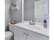 Well-lit bathroom with a white single sink vanity and decorative shelving above the toilet at 1710 Meadowchase Ct, Snellville, GA 30078