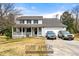 Charming two-story home with a welcoming front porch and attached two-car garage at 1710 Meadowchase Ct, Snellville, GA 30078