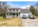 Charming two-story home featuring a welcoming front porch and attached two-car garage at 1710 Meadowchase Ct, Snellville, GA 30078