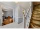 Foyer with staircase, white wainscoting and tile floors leading to the living room at 1710 Meadowchase Ct, Snellville, GA 30078