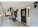 Inviting covered front porch with rocking chairs, a swing, and decorative lanterns at 1710 Meadowchase Ct, Snellville, GA 30078