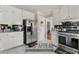 Functional kitchen with stainless steel appliances, white cabinets, and tile backsplash for easy maintenance at 1710 Meadowchase Ct, Snellville, GA 30078