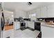 Functional kitchen with white cabinets, black tiled backsplash, and stainless steel appliances at 1710 Meadowchase Ct, Snellville, GA 30078