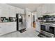 Kitchen featuring white cabinets, stainless steel appliances, and tiled flooring at 1710 Meadowchase Ct, Snellville, GA 30078