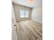 Bright bedroom with large window, wood-look floors, and neutral paint at 6022 Fieldcrest Dr, Morrow, GA 30260