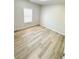 Bright bedroom with light gray walls and wood-look flooring, illuminated by natural light at 6022 Fieldcrest Dr, Morrow, GA 30260