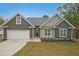 Charming home with a front-facing garage, neutral color palette, and a well-manicured front yard at 92 Fairview Oak Trce, Dallas, GA 30157