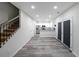 Hallway shot of an open kitchen area, showing the wood floors, stairs, and stainless steel appliances at 92 Fairview Oak Trce, Dallas, GA 30157