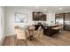 Well-lit dining area with wood floors, a round table, and dark brown kitchen cabinets at 956 Elwood St, Dacula, GA 30019