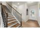 Inviting entryway with a staircase, wood floors, and a decorative window near the front door at 956 Elwood St, Dacula, GA 30019