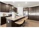 Modern kitchen featuring granite countertops, stainless steel appliances, and an island with barstool seating at 956 Elwood St, Dacula, GA 30019