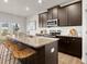 A kitchen area featuring an island with barstool seating and stainless steel appliances at 956 Elwood St, Dacula, GA 30019