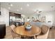 Open kitchen and dining area with modern dark brown cabinetry and stainless steel appliances at 956 Elwood St, Dacula, GA 30019