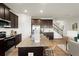 Modern kitchen with stainless steel appliances, granite countertops, and dark wood cabinets at 956 Elwood St, Dacula, GA 30019