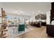 Inviting living room open to the kitchen featuring hardwood floors, and modern decor at 956 Elwood St, Dacula, GA 30019