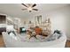 Bright living room featuring a modern ceiling fan, stylish shelves, and a comfortable curved sofa at 956 Elwood St, Dacula, GA 30019