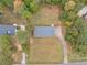 Aerial view showing the house, long driveway and large grass yard surrounded by trees at 1605 Mcgarity Rd, Mcdonough, GA 30252