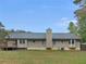 Back exterior of house with a deck and a large backyard at 1605 Mcgarity Rd, Mcdonough, GA 30252