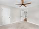 Cozy carpeted bedroom with a ceiling fan and two white doors at 1605 Mcgarity Rd, Mcdonough, GA 30252