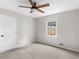 Bedroom with a ceiling fan, carpeted floors, and a bright window at 1605 Mcgarity Rd, Mcdonough, GA 30252