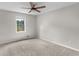 Bedroom featuring neutral walls and carpeted floor. It features a window and ceiling fan at 1605 Mcgarity Rd, Mcdonough, GA 30252