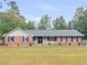 Charming brick home with a well-maintained lawn and inviting front porch at 1605 Mcgarity Rd, Mcdonough, GA 30252