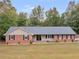 Classic brick home with a tidy front lawn and a welcoming front porch at 1605 Mcgarity Rd, Mcdonough, GA 30252