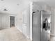 Kitchen area with stainless steel refrigerator, door to outside, and neutral tile flooring at 1605 Mcgarity Rd, Mcdonough, GA 30252