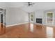 Bright living room features hardwood floors, a fireplace, and a ceiling fan at 1605 Mcgarity Rd, Mcdonough, GA 30252