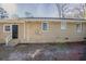 Back exterior view of home highlighting the entrance, siding, and fenced backyard at 1932 Rosewood Rd, Decatur, GA 30032