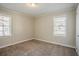 This bedroom provides a neutral space with carpet flooring and natural lighting perfect for relaxation at 1932 Rosewood Rd, Decatur, GA 30032