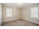 A well-lit bedroom offers neutral walls and carpet, creating a blank canvas for personalization at 1932 Rosewood Rd, Decatur, GA 30032