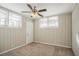 A naturally lit bedroom with a ceiling fan, neutral walls, and light-colored carpet at 1932 Rosewood Rd, Decatur, GA 30032