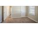 Bedroom featuring neutral walls, carpeted floor, window with blinds, and hallway view at 1932 Rosewood Rd, Decatur, GA 30032