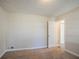 Bedroom featuring neutral walls, carpeted floor, and a door leading to another room at 1932 Rosewood Rd, Decatur, GA 30032